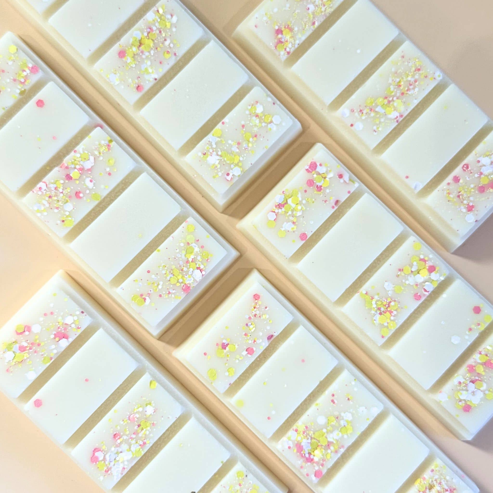 Lemon meringue scented wax melt snap bars flat lay on apricot coloured background