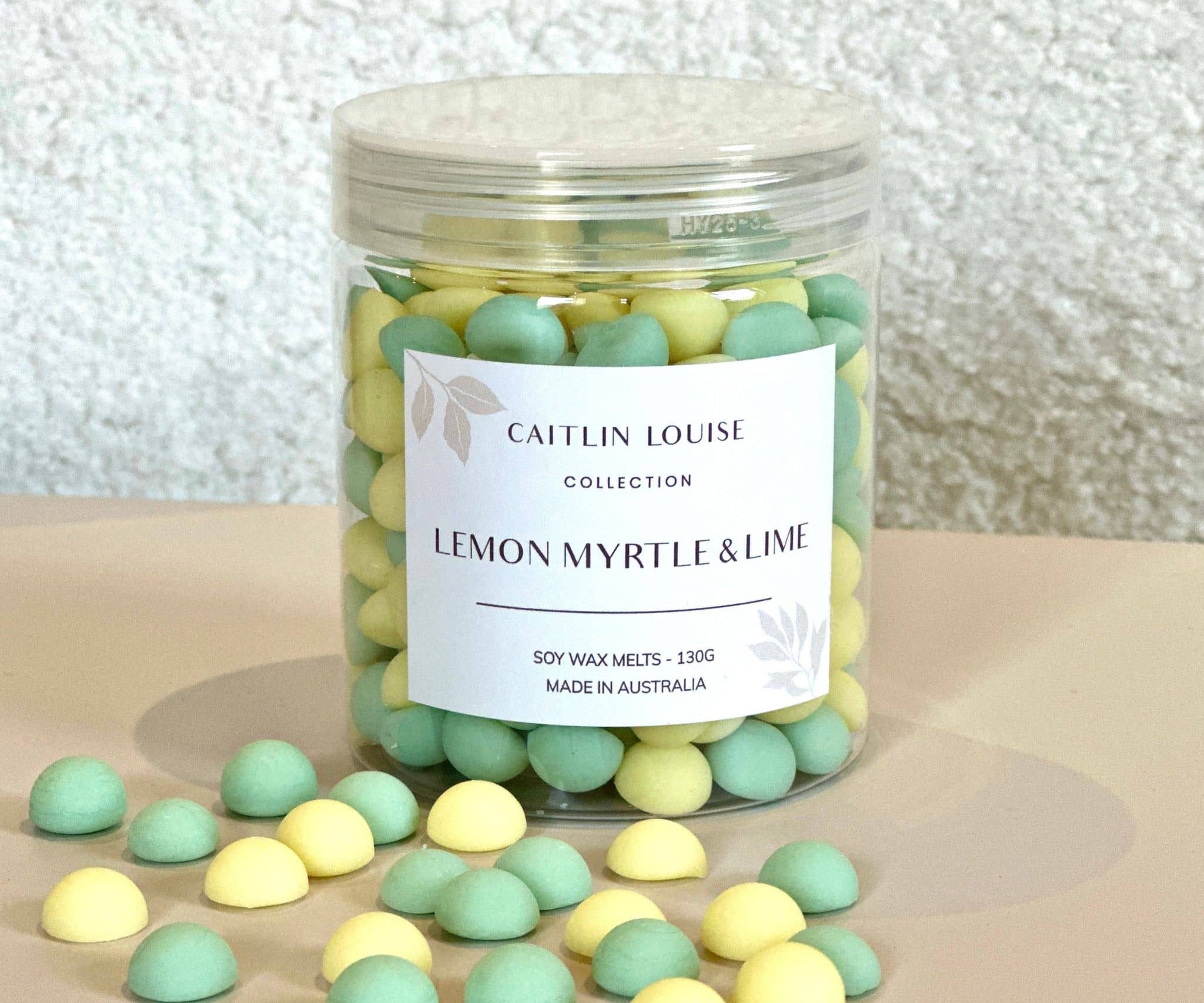 Caitlin Louise Collection's Lemon Myrtle and Lime Wax Melt pebbles in a jar.