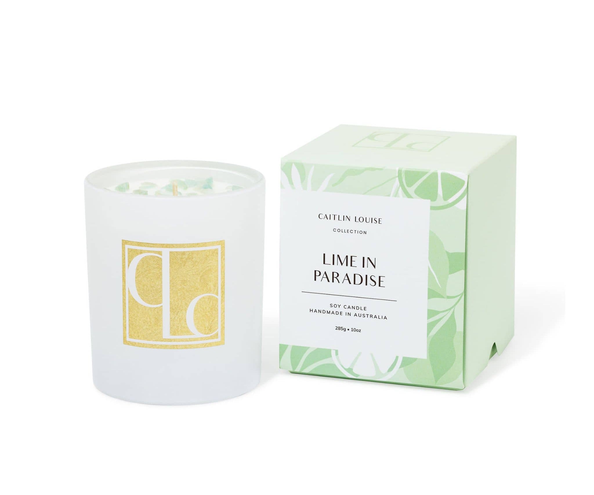 Candle with packaging labeled 'Lime in Paradise' by Caitlin Louise Collection on a white background