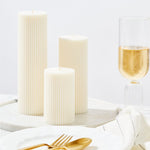 Lumiere pillar candles - trio of sizes - styled on dining table with champagne