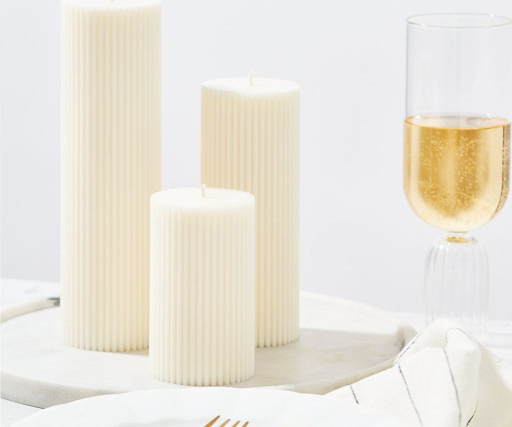 Lumiere pillar candles - trio of sizes - styled on dining table with champagne