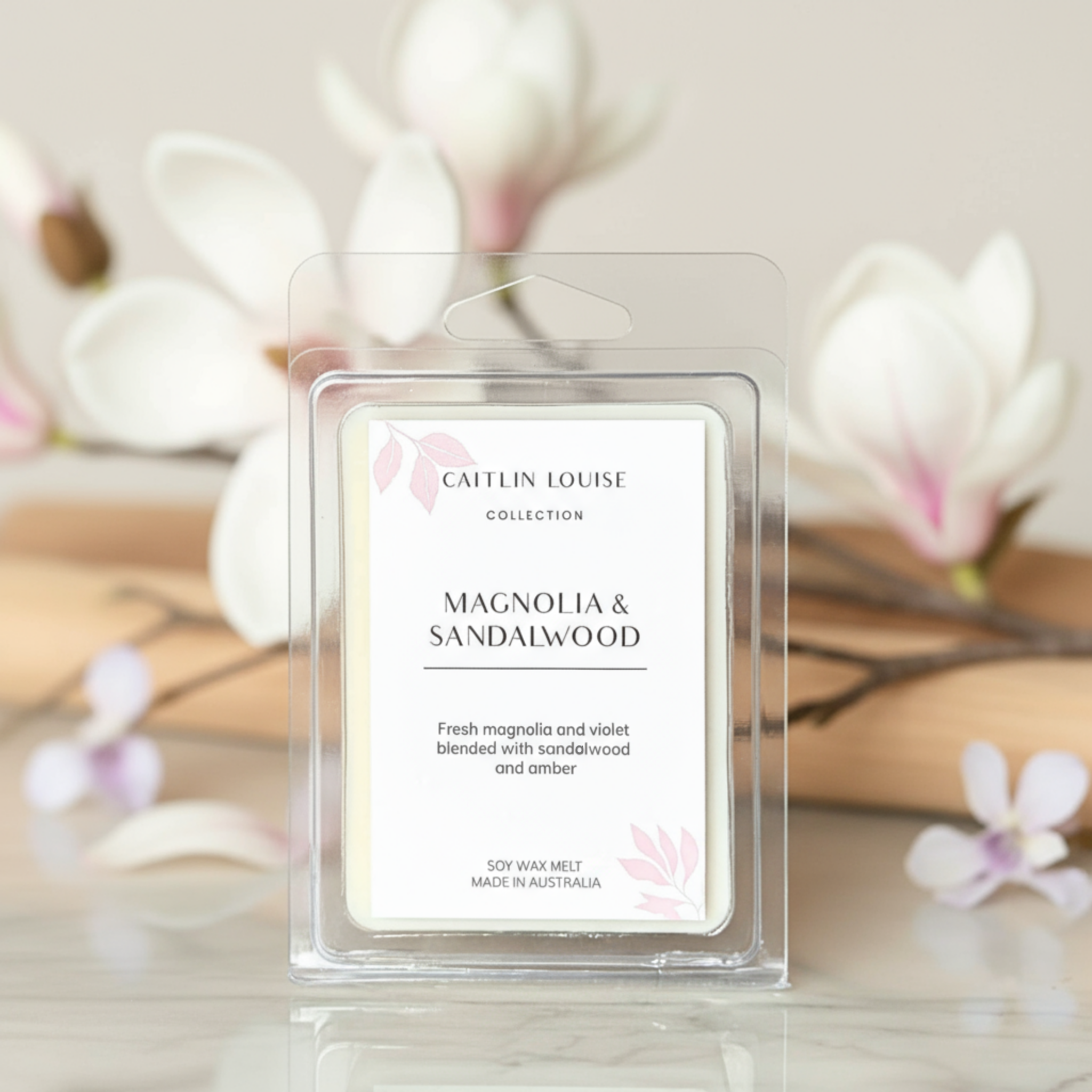 Caitlin Louise Magnolia & Sandalwood wax melt packaging with floral background