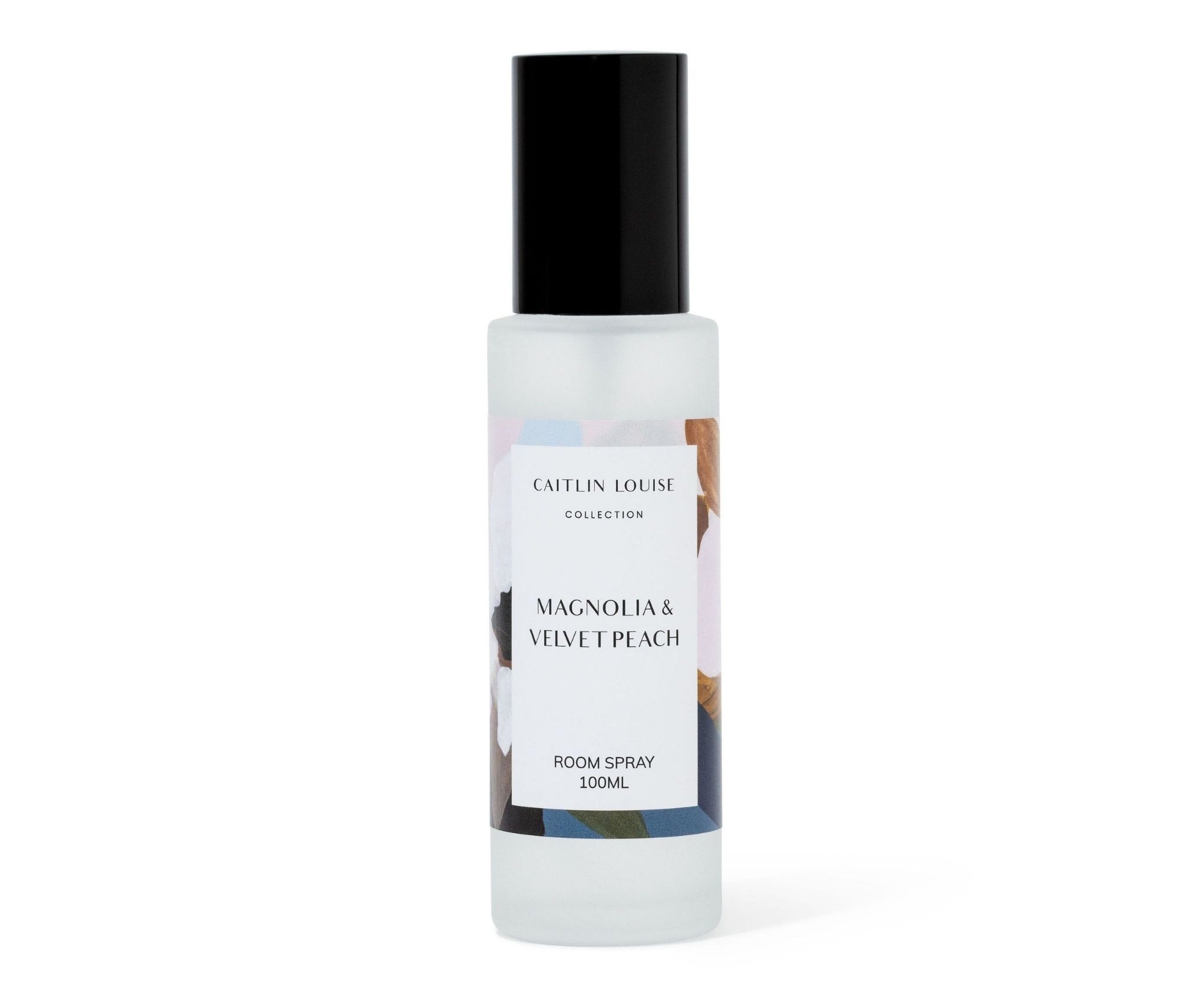Room spray bottle labeled 'Caitlin Louise Collection Magnolia & Velvet Peach' on a white background