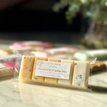 Close up of Caitlin Louise Collection's Passionfruit and Paw Paw Soy Wax Melt Snap Bar on coffee table