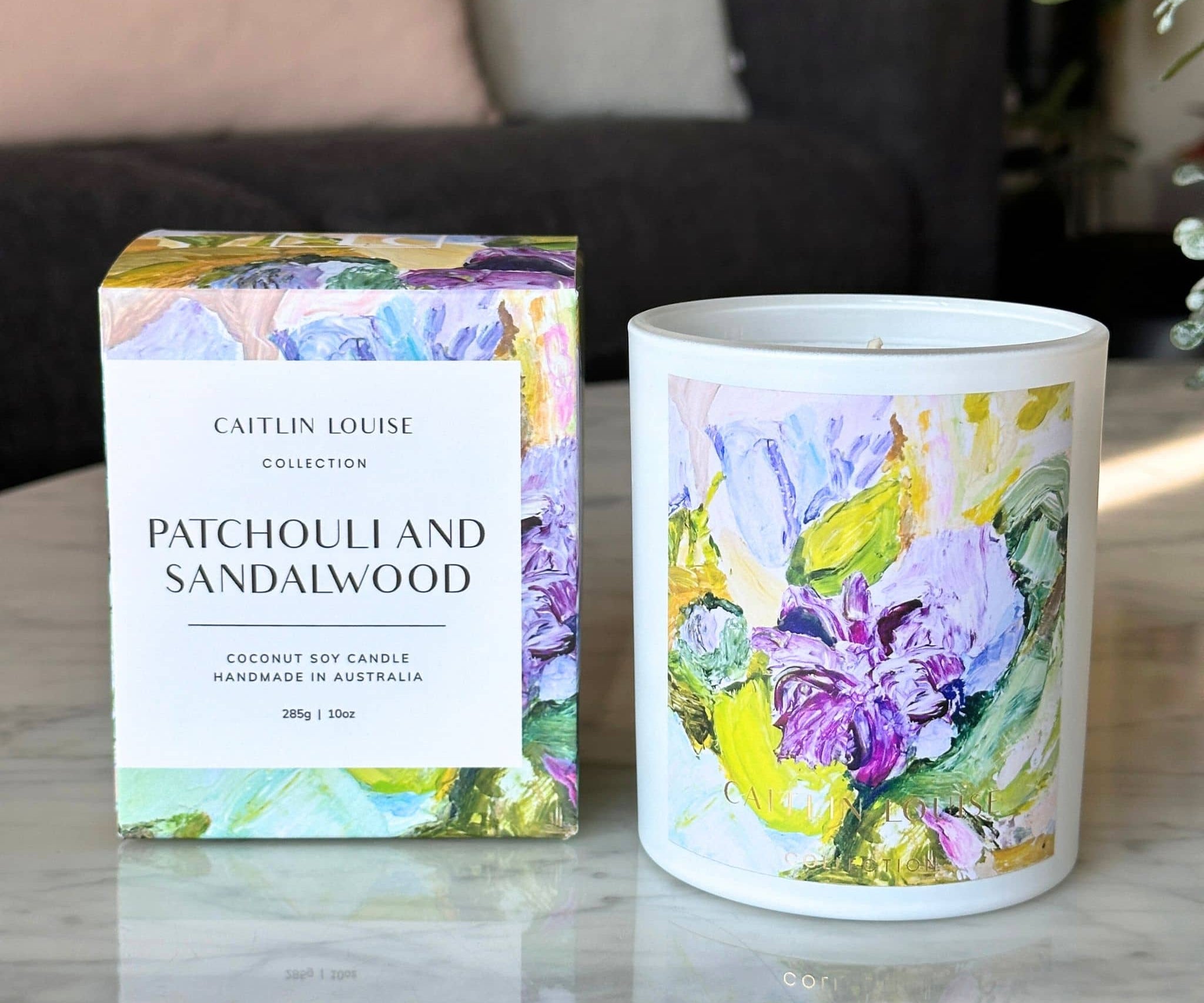 Patchouli and sandalwood artist candle with box on coffee table