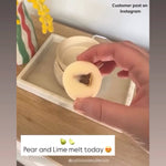 Hand holding a wax melt disk with a dried lime center on a wooden surface, with text indicating a customer post on Instagram.