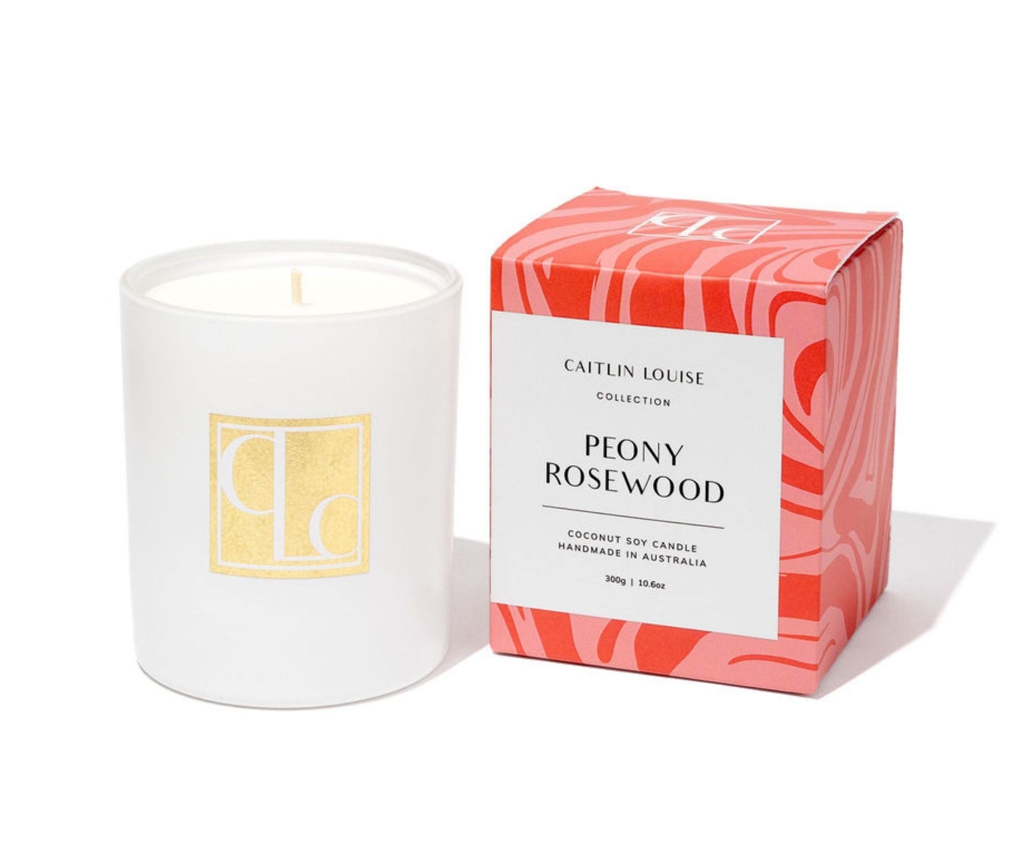 Caitlin Louise Collection candle with a red and pink patterned box labeled 'Peony Rosewood' on a white background