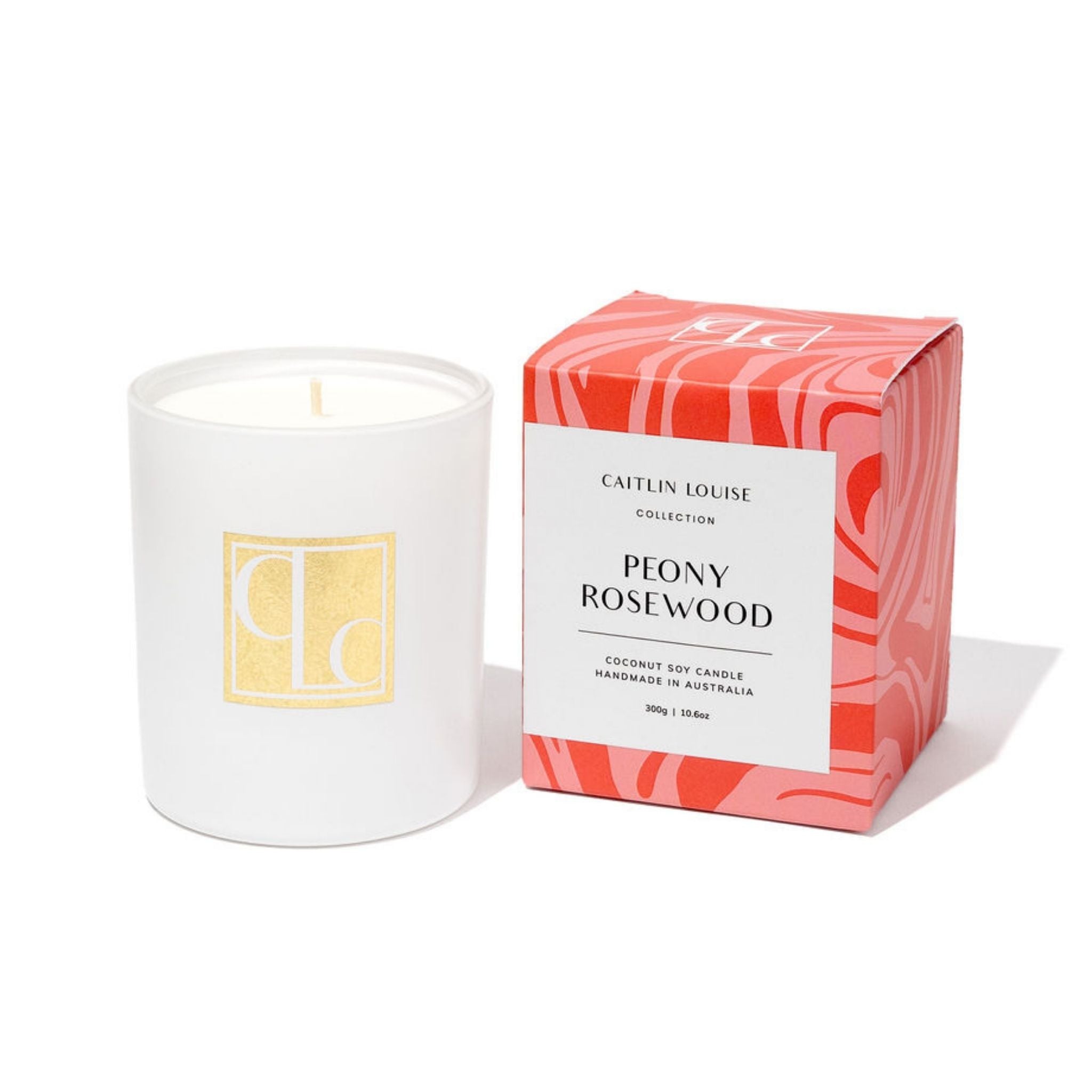 Caitlin Louise Collection candle with a red and pink patterned box labeled 'Peony Rosewood' on a white background