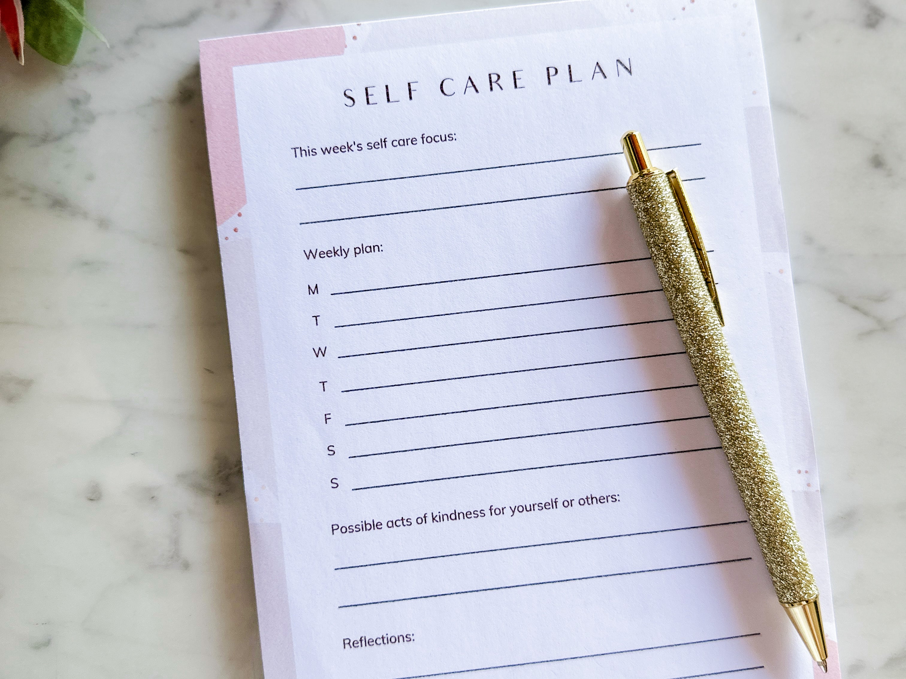 Caitlin Louise Collection self-care plan notepad on marble coffee table with pen