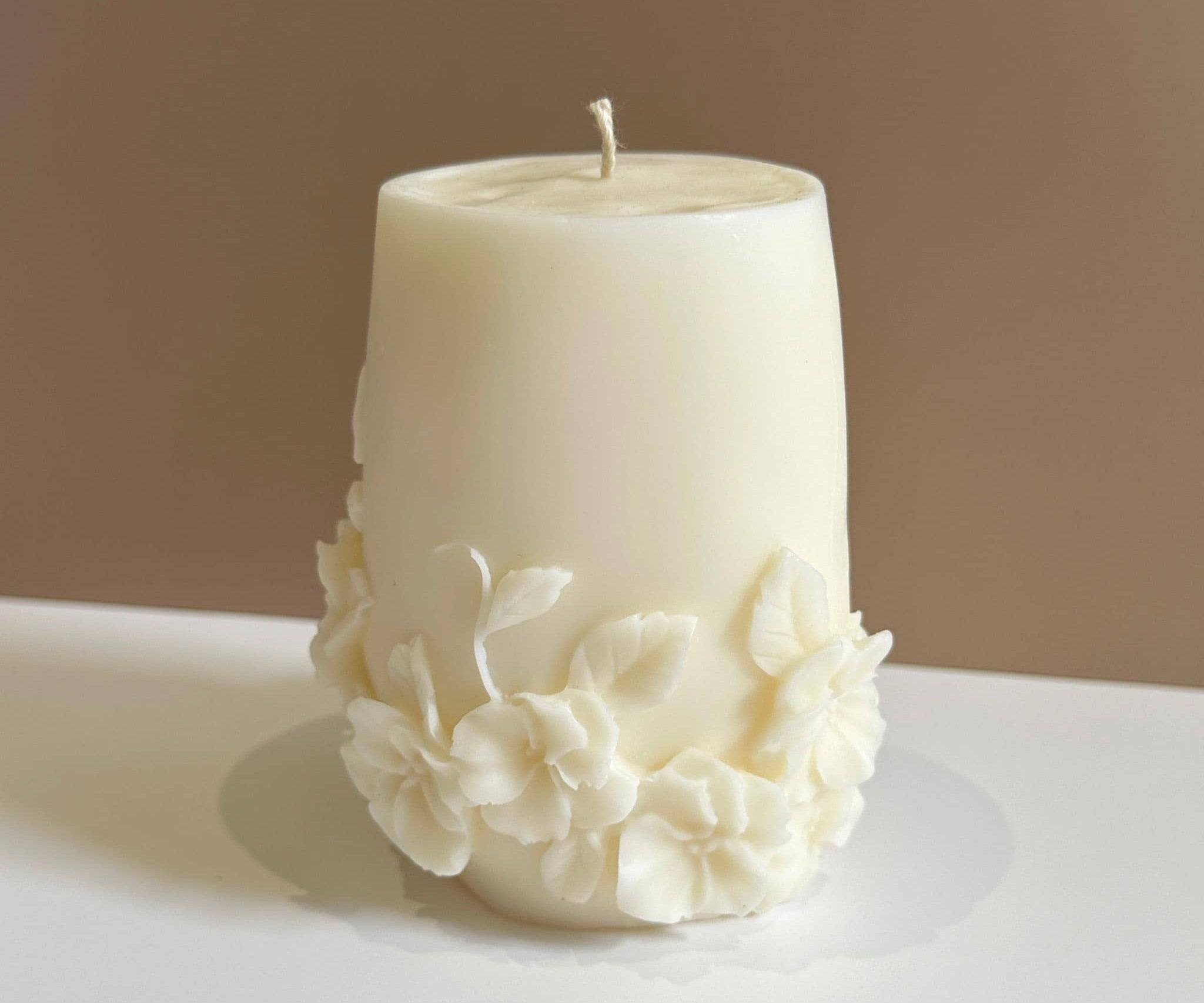 Caitlin Louise Collection Seraphina Sculptural Candle on white base - brown background