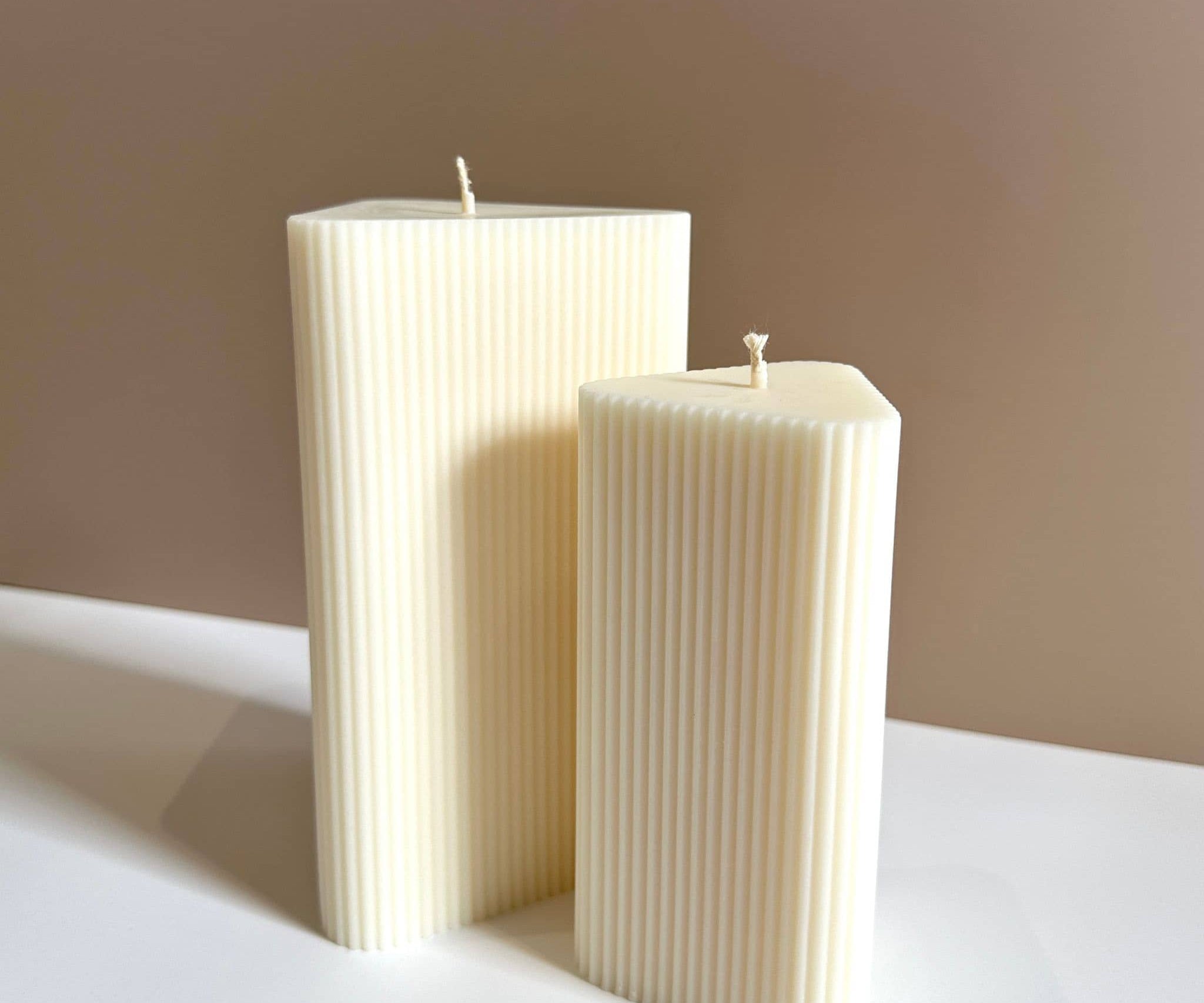 Caitlin Louise Collections small and large stria pillar candles - brown background