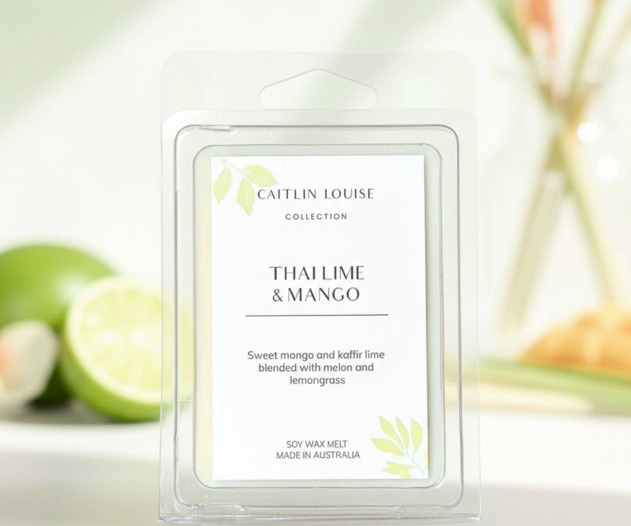 Caitlin Louise Thai Lime & Mango wax melt packaging with limes in the background