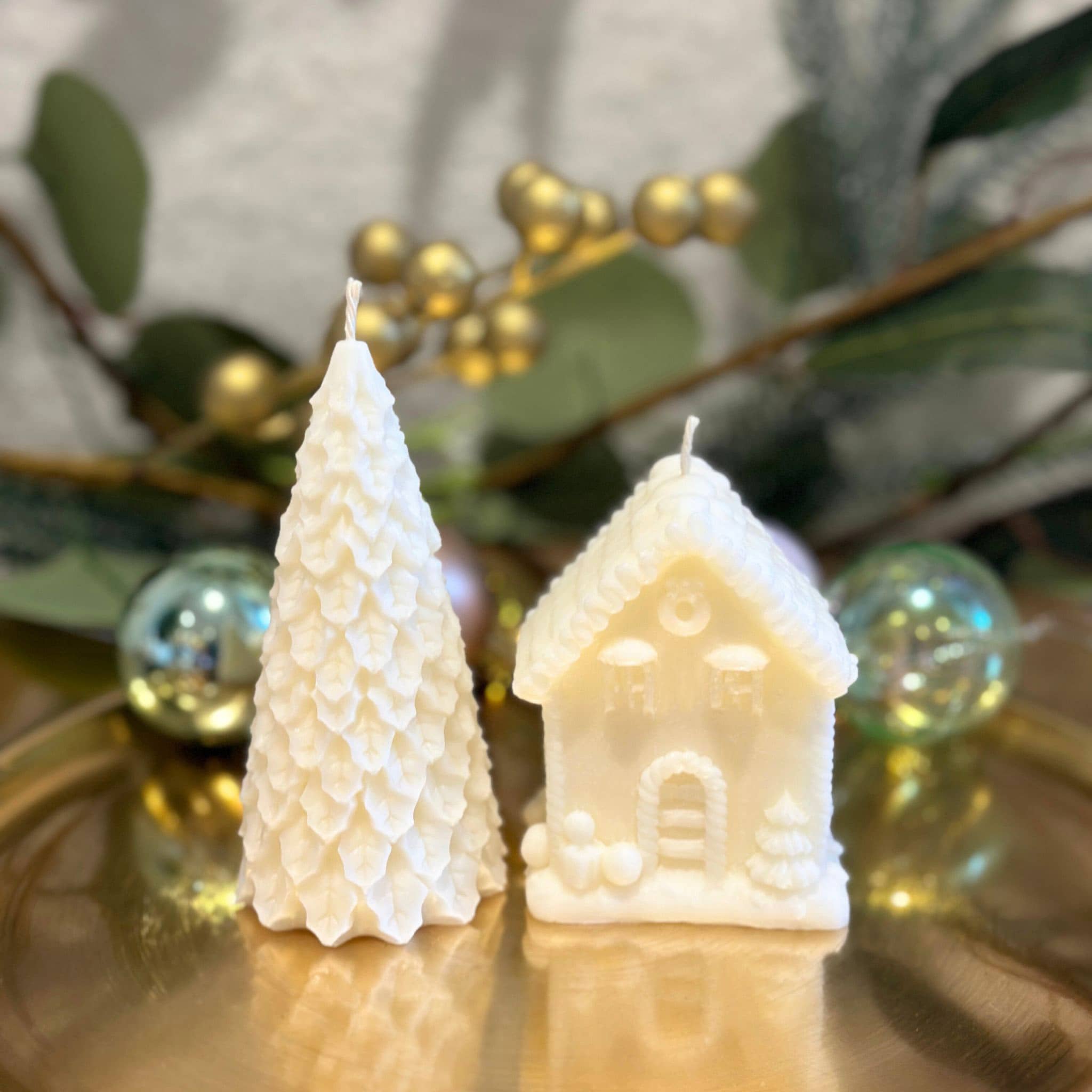 Christmas sculptural candles - tree and house on gold tray with wreath in background