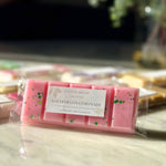 Close up of Caitlin Louise Collection's Watermelon Lemonade Soy Wax Melt Snap Bar on coffee table