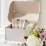 Subscription box containing wax melts with a bouquet of flowers on a white background