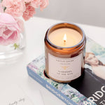Caitlin Louise Collection Whispers of the Ton Bookish Candle - styled with flowers and Bridgerton book - close up