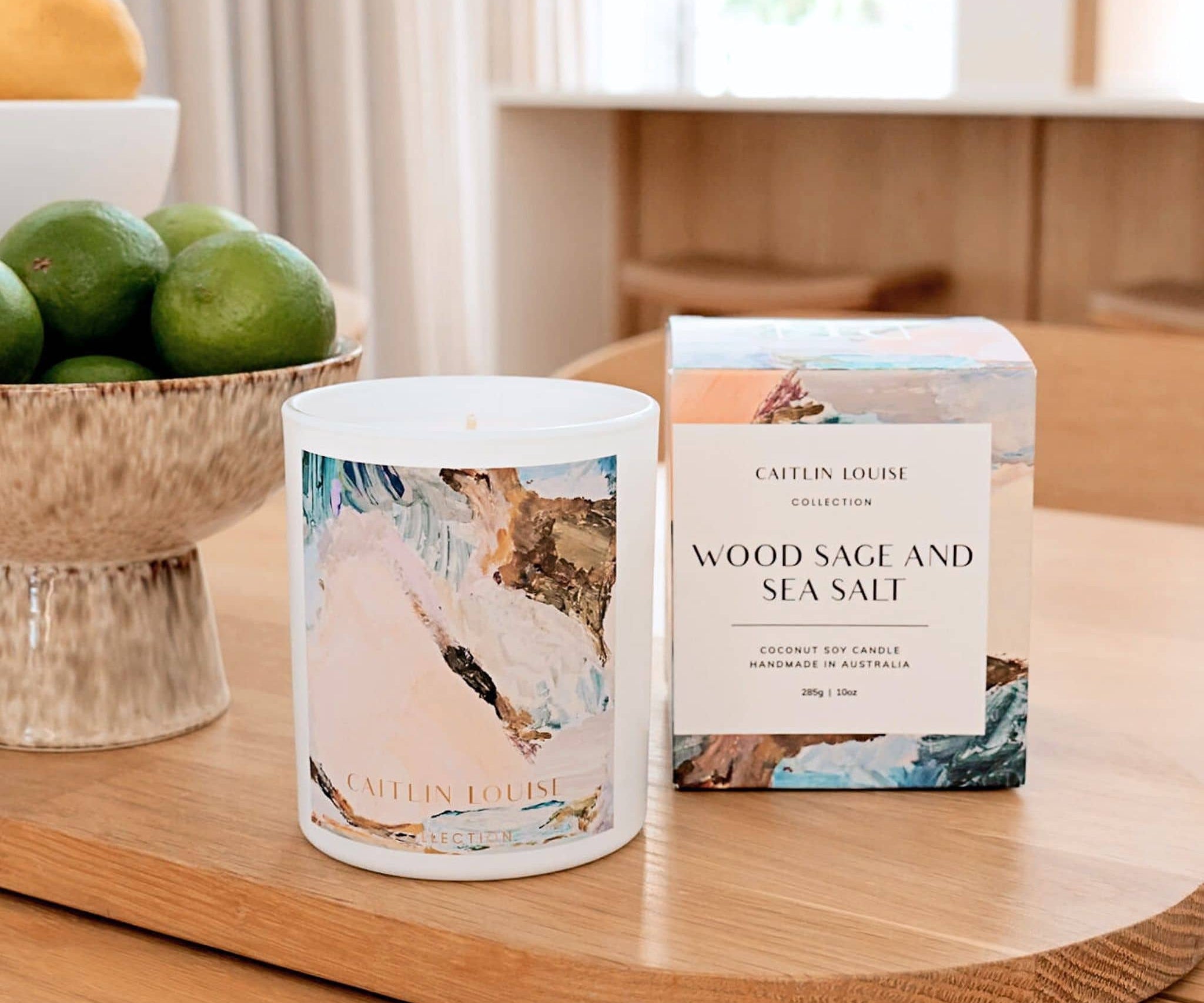Caitlin Louise Collection Wood Sage and Sea Salt Annie Everingham Artist Candle - styled on dining table
