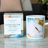 Wood sage and sea salt artist candle next to box on coffee table