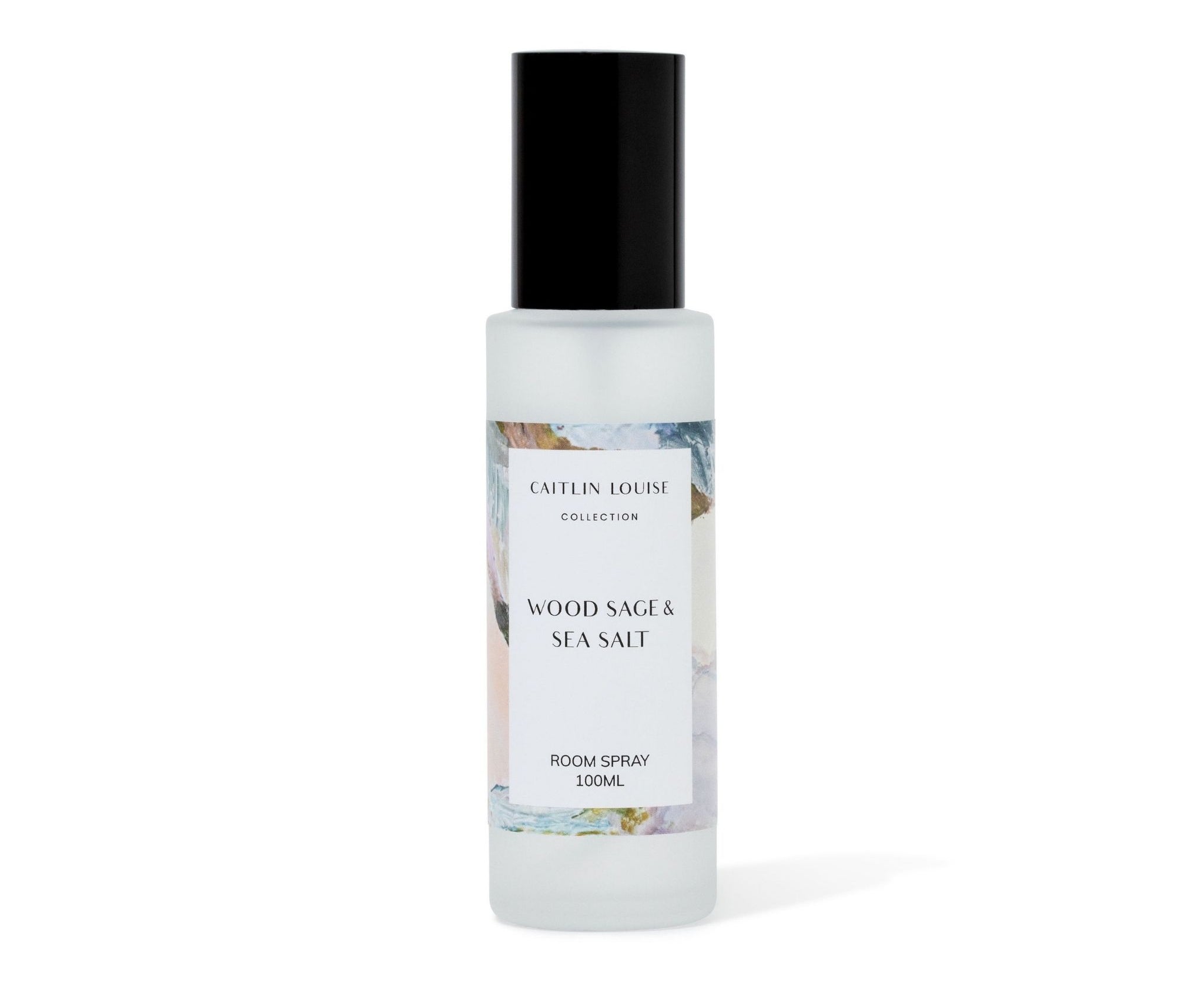 Room spray bottle labeled 'Wood Sage & Sea Salt' by Caitlin Louise Collection on a white background